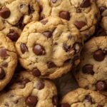 Freshly baked chocolate chip cookies cooling on a wire rack