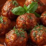 Healthy homemade hidden veggie meatballs garnished with fresh herbs on a rustic wooden table
