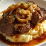 French Onion Pot Roast over creamy mashed potatoes with caramelized onions and rich gravy — hearty slow‑cooked beef dinner recipe