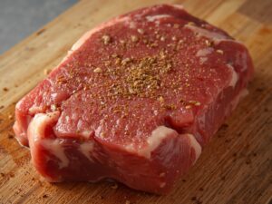 Seasoned raw beef chuck roast ready for cooking Title: Seasoning Beef