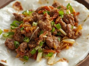 Beef mixture placed on rice-paper wrapper