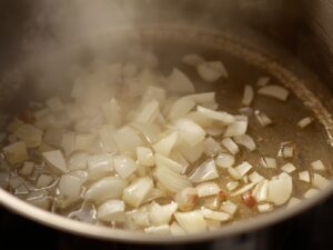Chopped onions sautéing in oil until translucent