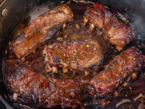 Golden-brown seared short ribs in Dutch oven