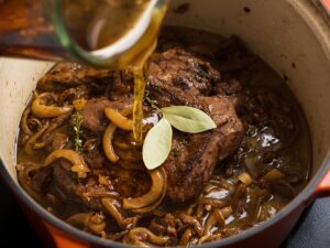 Slow-cooking beef pot roast with caramelized onions and herbs