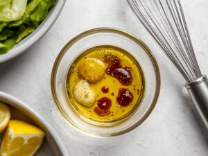 Lemon and olive oil dressing prepared for salad.