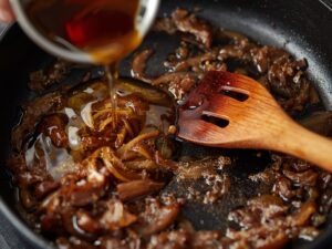 Deglazing skillet with broth or wine for French Onion Pot Roast